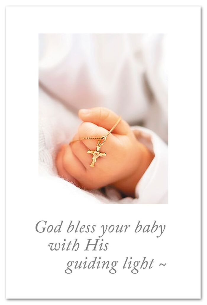 Cross necklace in babies hand baptism card.